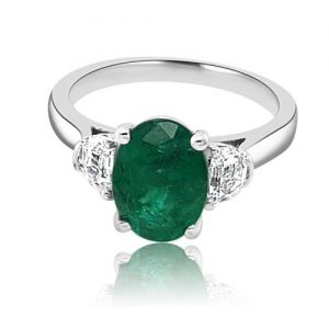 PLATINUM OVAL EMERALD & HALF MOON DIAMOND 3 Green emerald engagement ring in hatton garden flat
