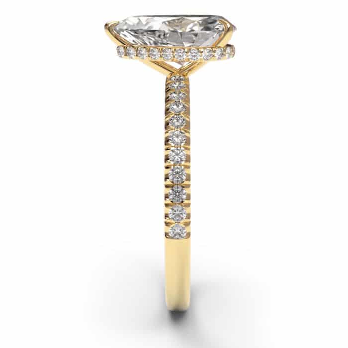 side view of a pear cut diamond shoulder engagement ring in yellow gold metal
