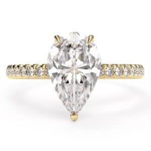 birds eye view of a pear cut diamond shoulder engagement ring in yellow gold metal
