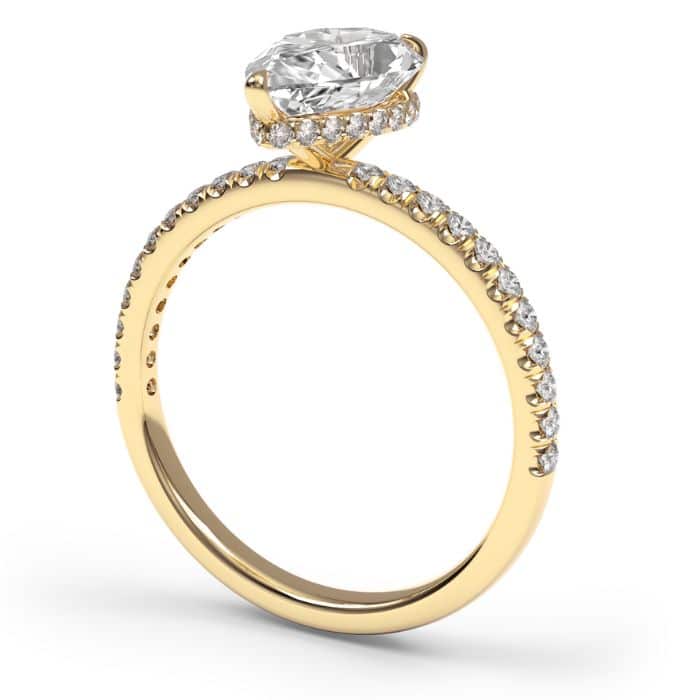 Image of a pear cut diamond shoulder engagement ring in yellow gold metal