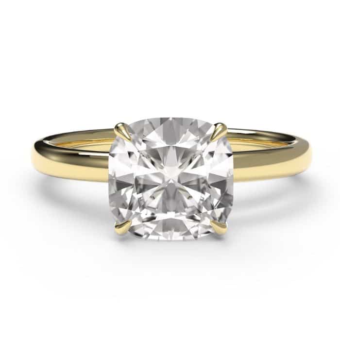 Birds eye view of a cushion cut diamond ring in a yellow gold band