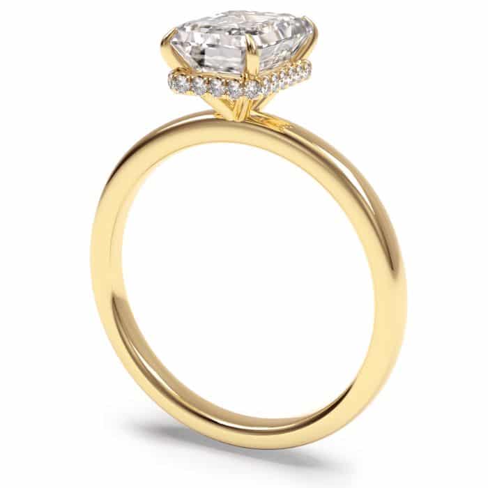 Gold Diamond ring with a hidden halo feature and an emerald cut centre stone