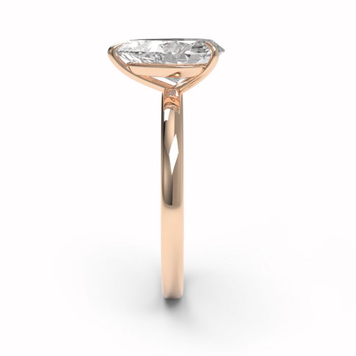 Image of a pear cut yellow gold diamond ring from the side