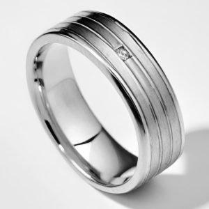 Mens platinum striped wedding band with brushed finish and small diamond platinum