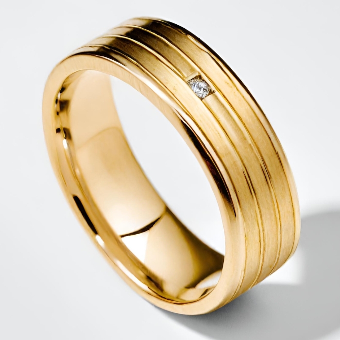Mens yellow gold striped wedding band with brushed finish and small diamond
