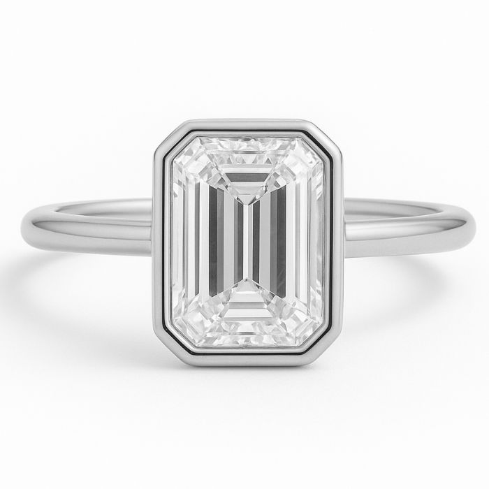 Bezel set diamond engagement ring with a emerald cut diamond in platinum