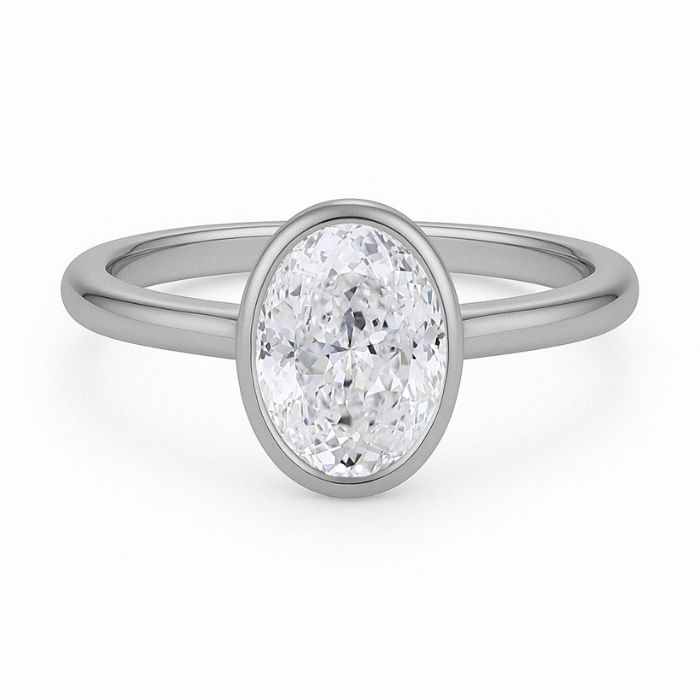 Bezel set diamond engagement ring with a oval brilliant cut diamond in platinum