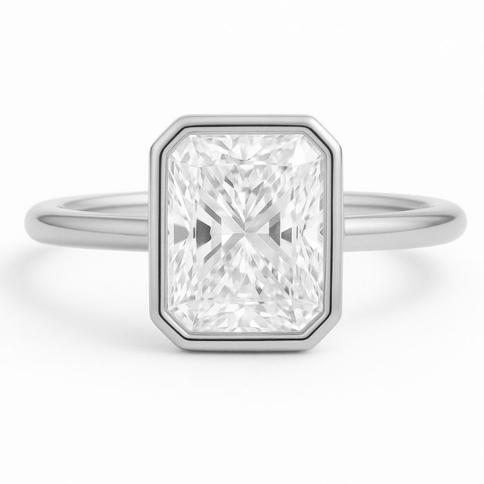 Bezel set diamond engagement ring with a radiant cut diamond in platinum