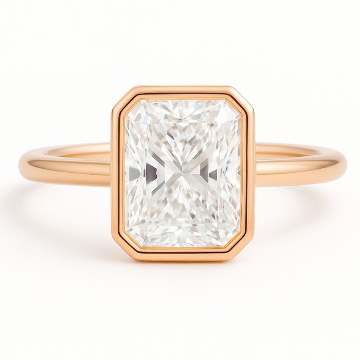 Bezel set diamond engagement ring with a radiant cut diamond in rose gold